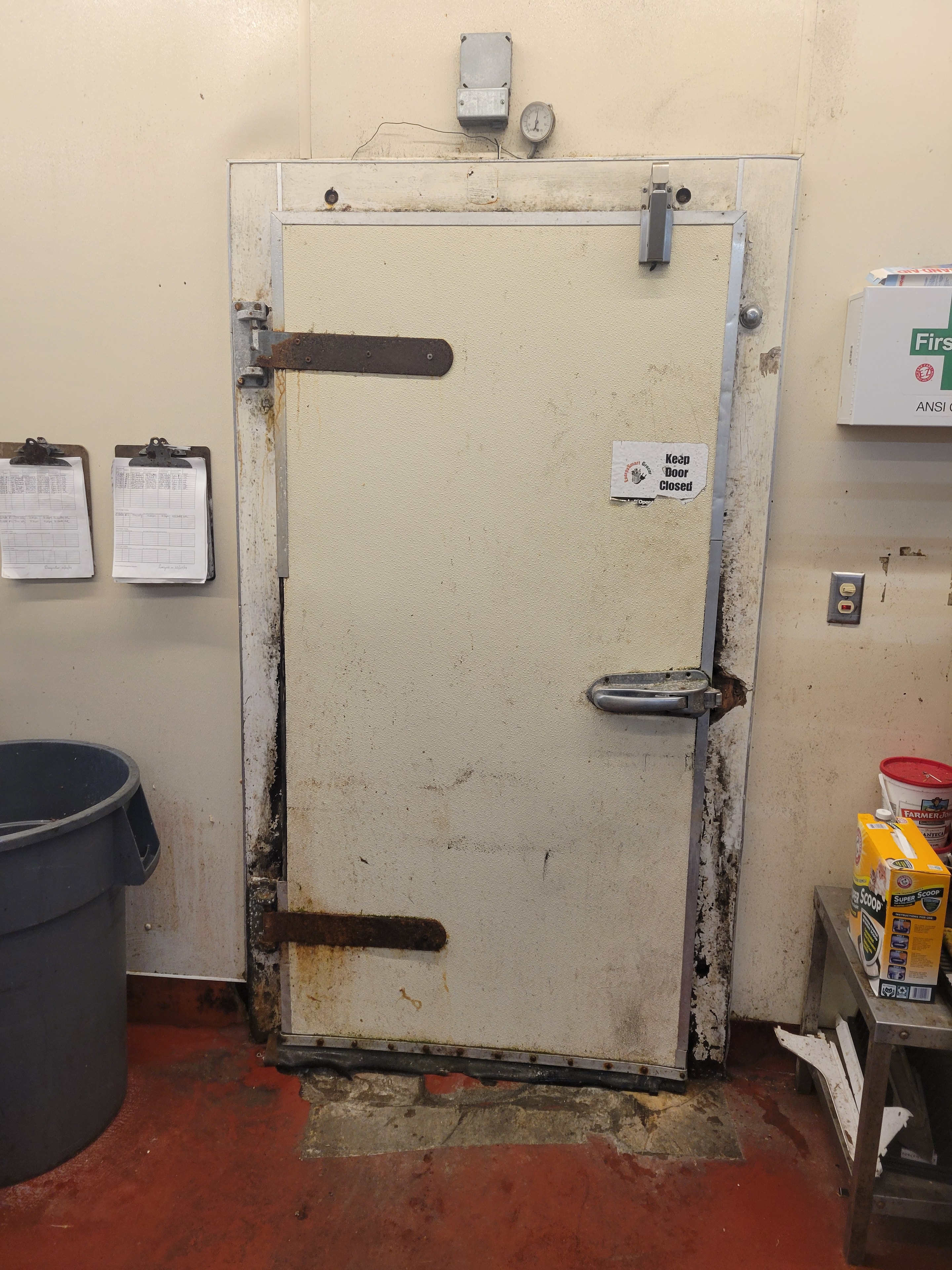 Original worn walk-in freezer door before repair