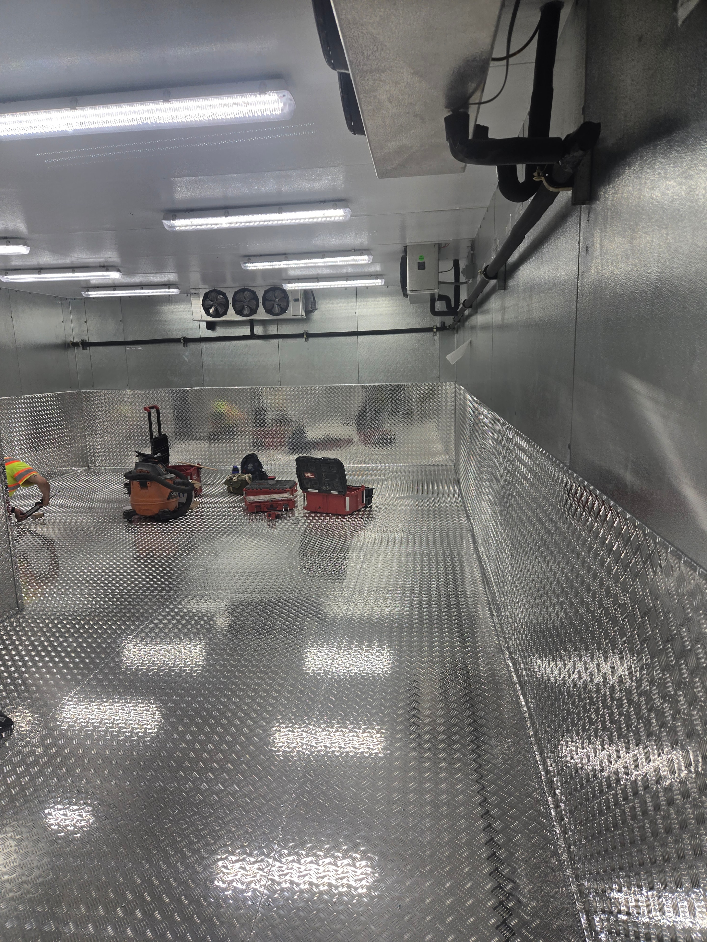 Finished diamond-plate floor repair inside a walk-in freezer